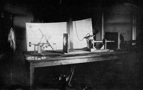 A black and white photograph of instruments on a table set up to record sound waves.