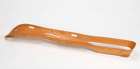 Plywood leg splint; long concave curved piece of wood with openings of different sizes throughout.